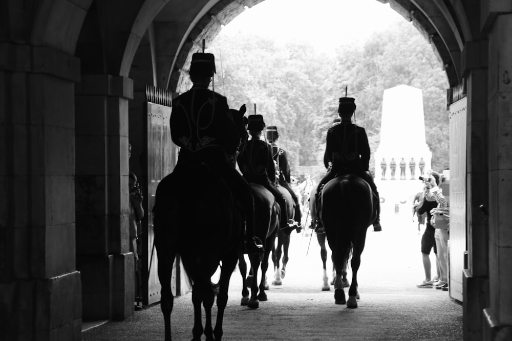 a group of men riding horses