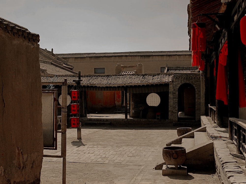 a courtyard with buildings and a sign