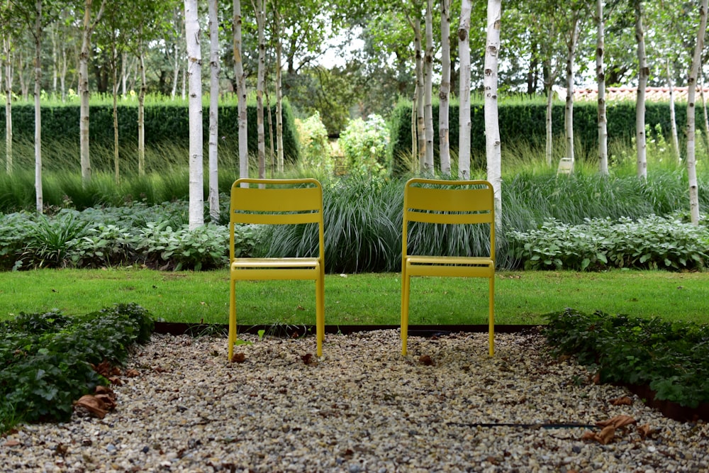 two yellow chairs in a garden