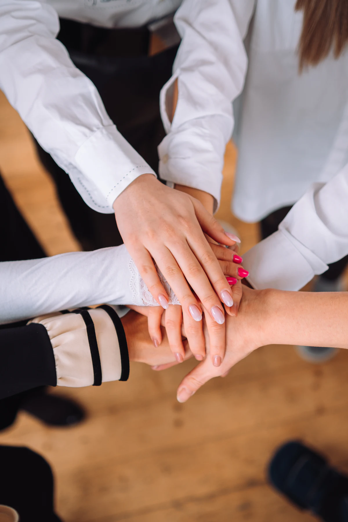 A group of colleagues shaking hands across a table