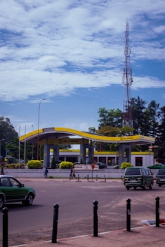 A busy petrol pump with vehicles lined up for fueling under clear skies.
