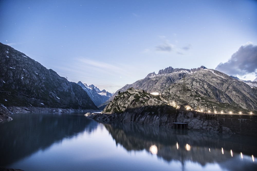 a body of water with mountains in the background