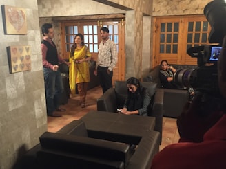Group of people watching TV together in a cozy living room.