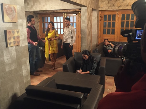 A friendly team of technicians installing smart home devices in a modern living room.