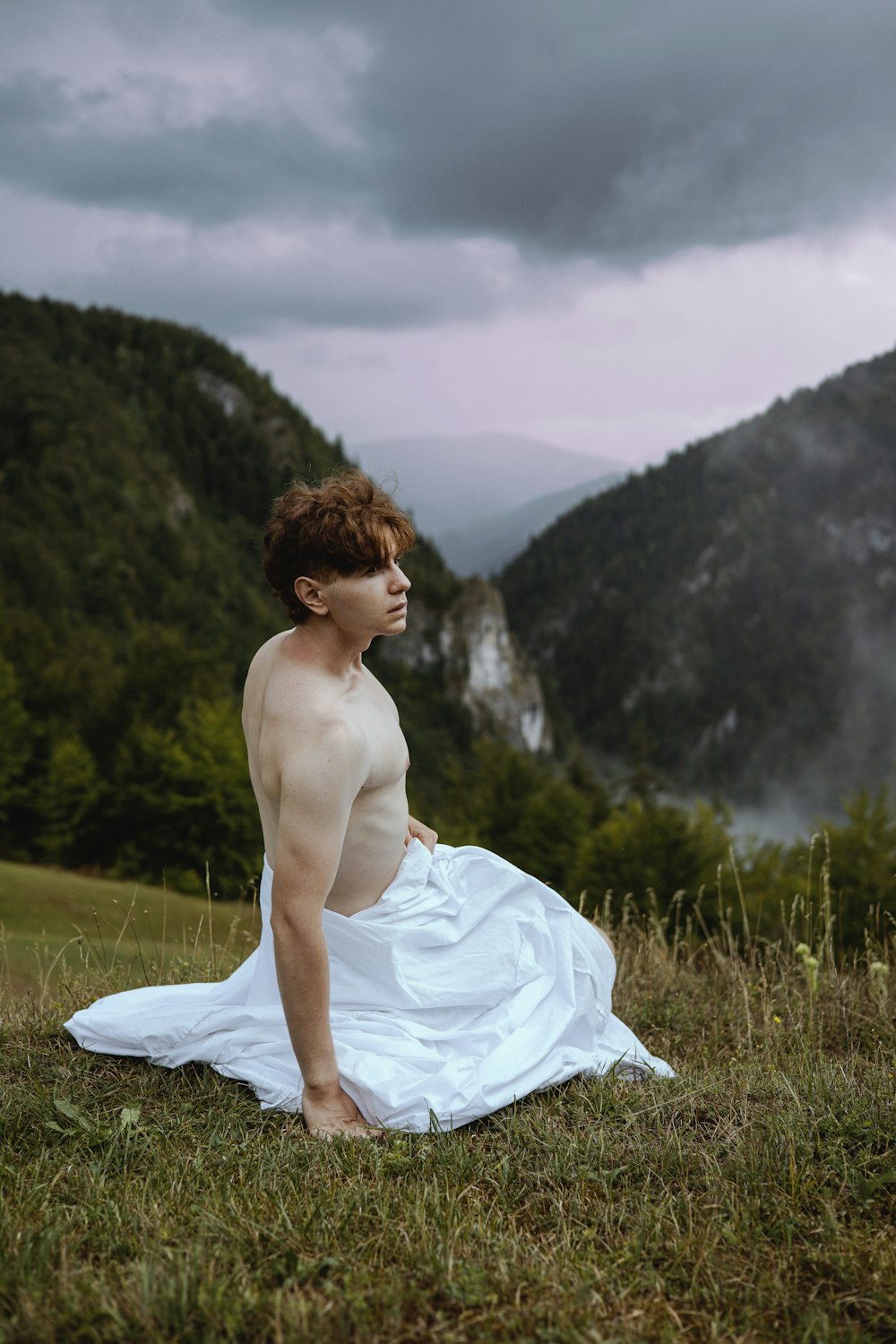 a man sitting in a field