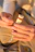 Close-up of hands unwrapping a sleek corporate gift hamper with a custom logo.
