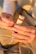 Close-up of hands unwrapping a sleek corporate gift hamper with a custom logo.