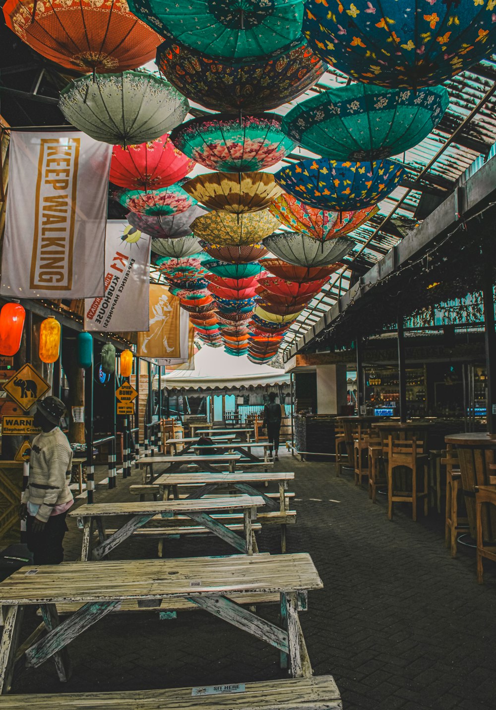 a street with tables and umbrellas