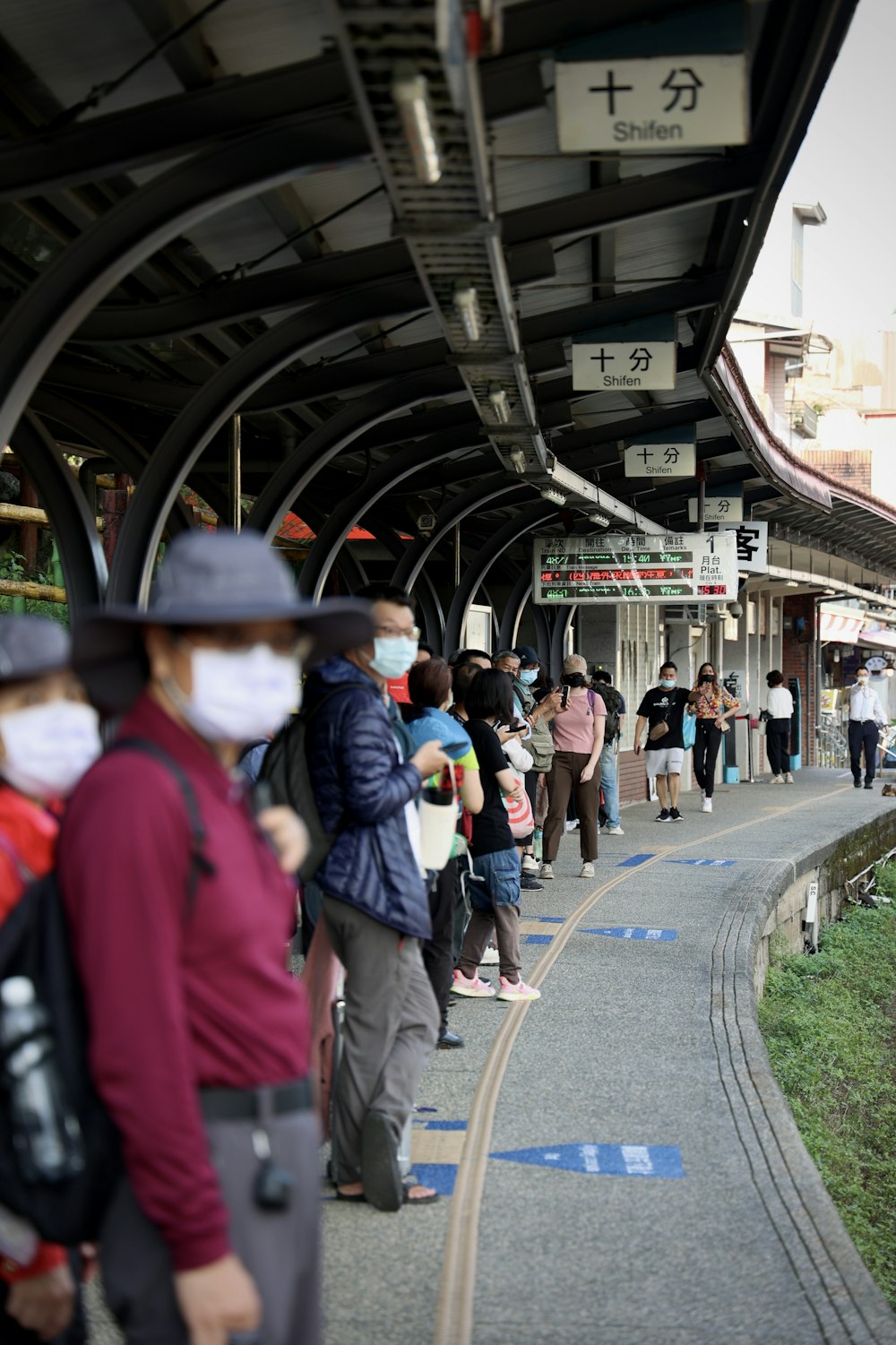 a group of people walking on a sidewalk