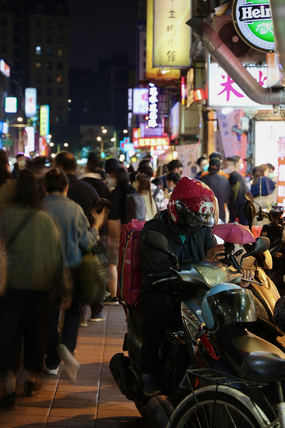 a person riding a motorcycle in a busy city