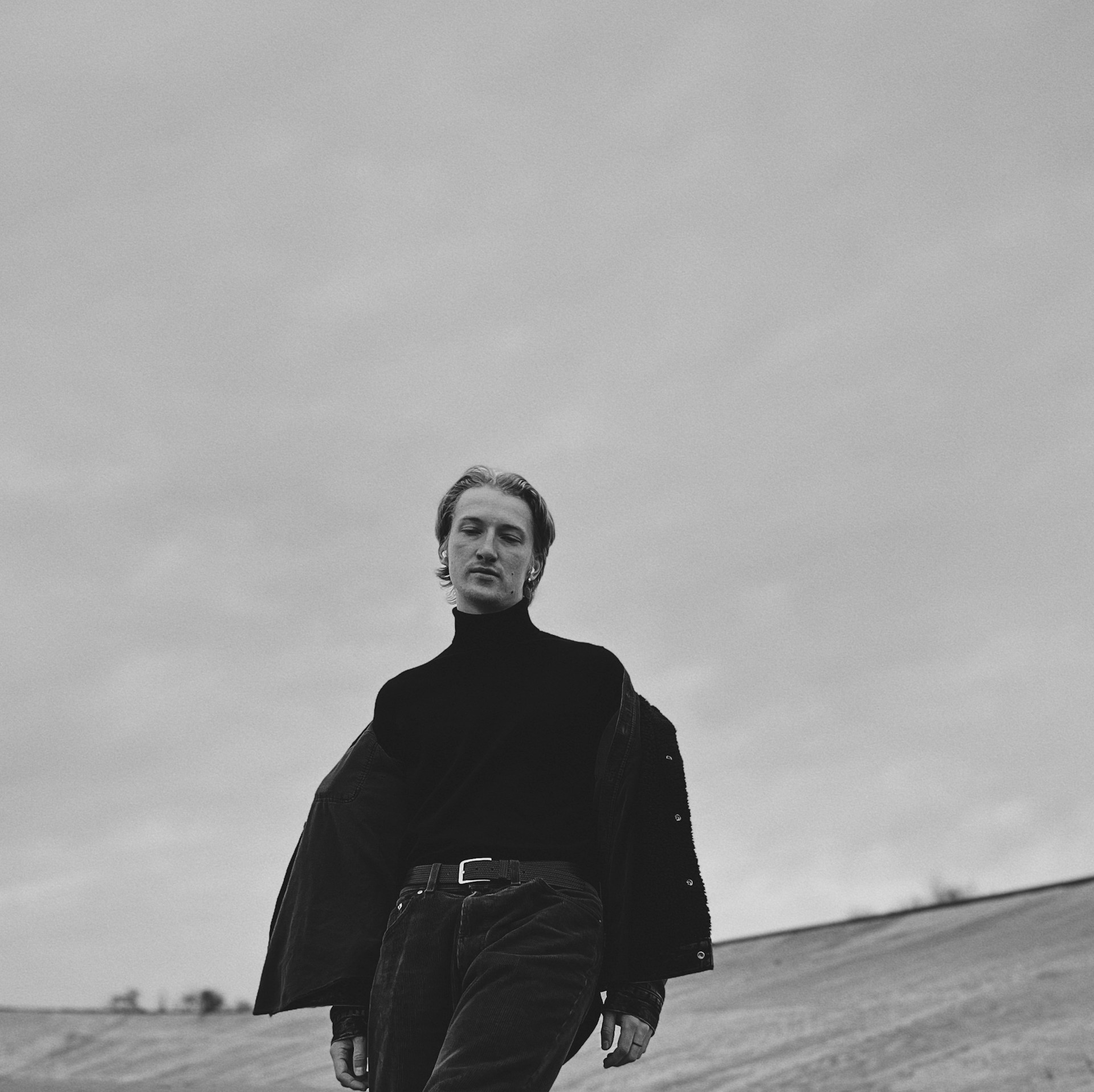 A sleek promotional photo of Sky Tero in a stylish dark jacket against a minimalist black background, embodying the modern and luxurious vibe of fullysyde records.