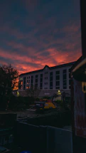 A sleek, modern construction site at dusk with golden light highlighting a premium framing project.