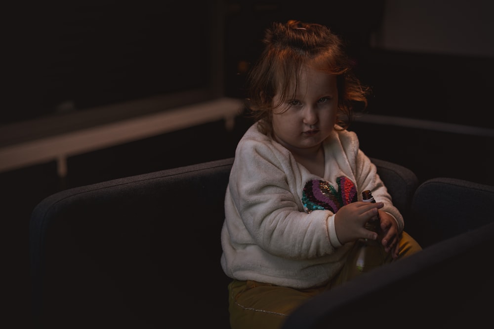 a girl sitting on a bench