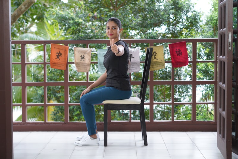 Active older adult doing a seated chair yoga stretch in a bright room