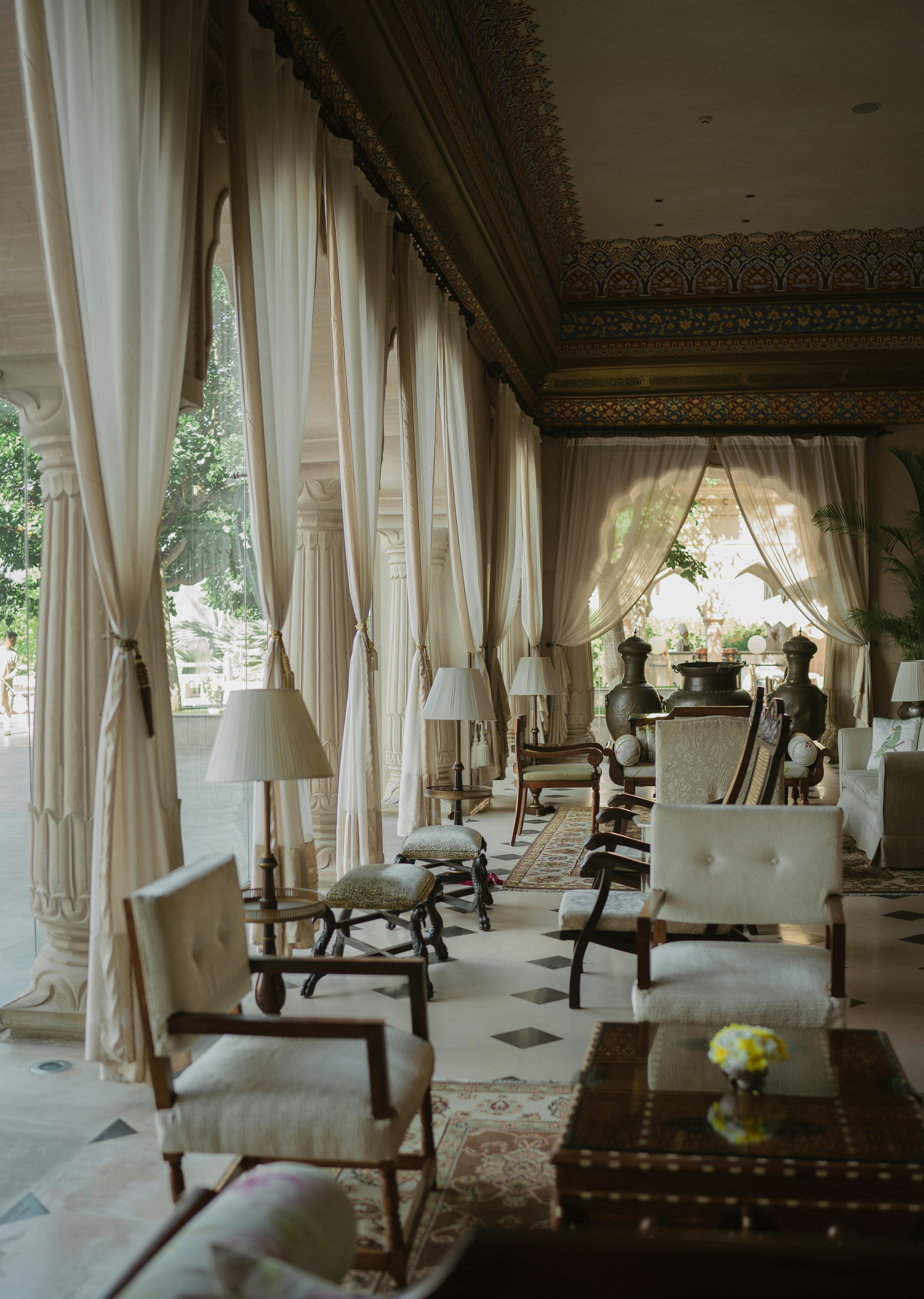 Luxury estate living room with ornate ceiling details, floor-to-ceiling drapes, and classical furnishings in San Francisco