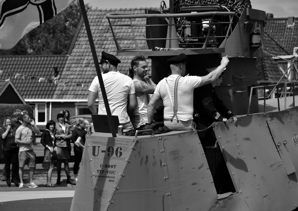 a group of people standing on a boat