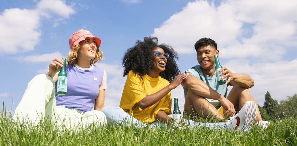 a group of people sitting on grass