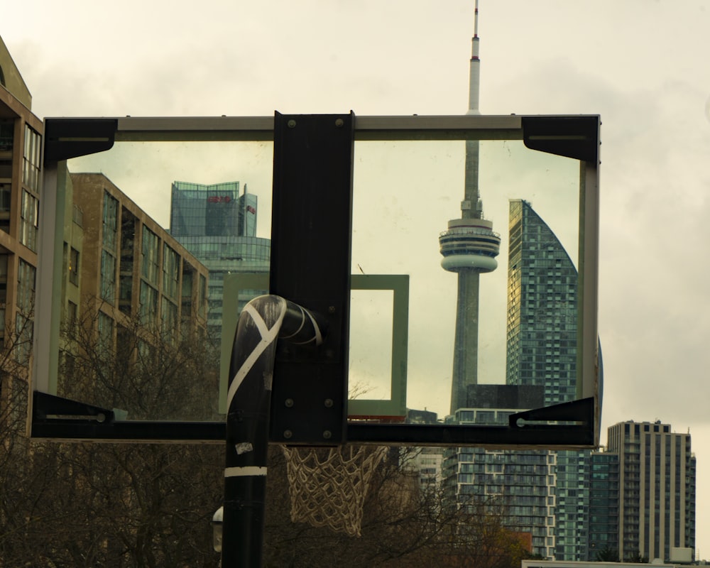 a city skyline with a large mirror