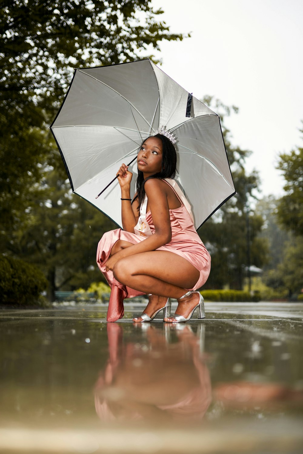 a woman sitting on a bench holding an umbrella