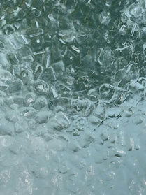 Close-up of clear ice cubes glistening under soft light