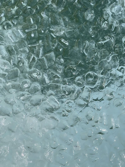 Close-up of crystal-clear gourmet ice cubes reflecting light beautifully.