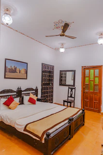 a bedroom with a bed and a chandelier