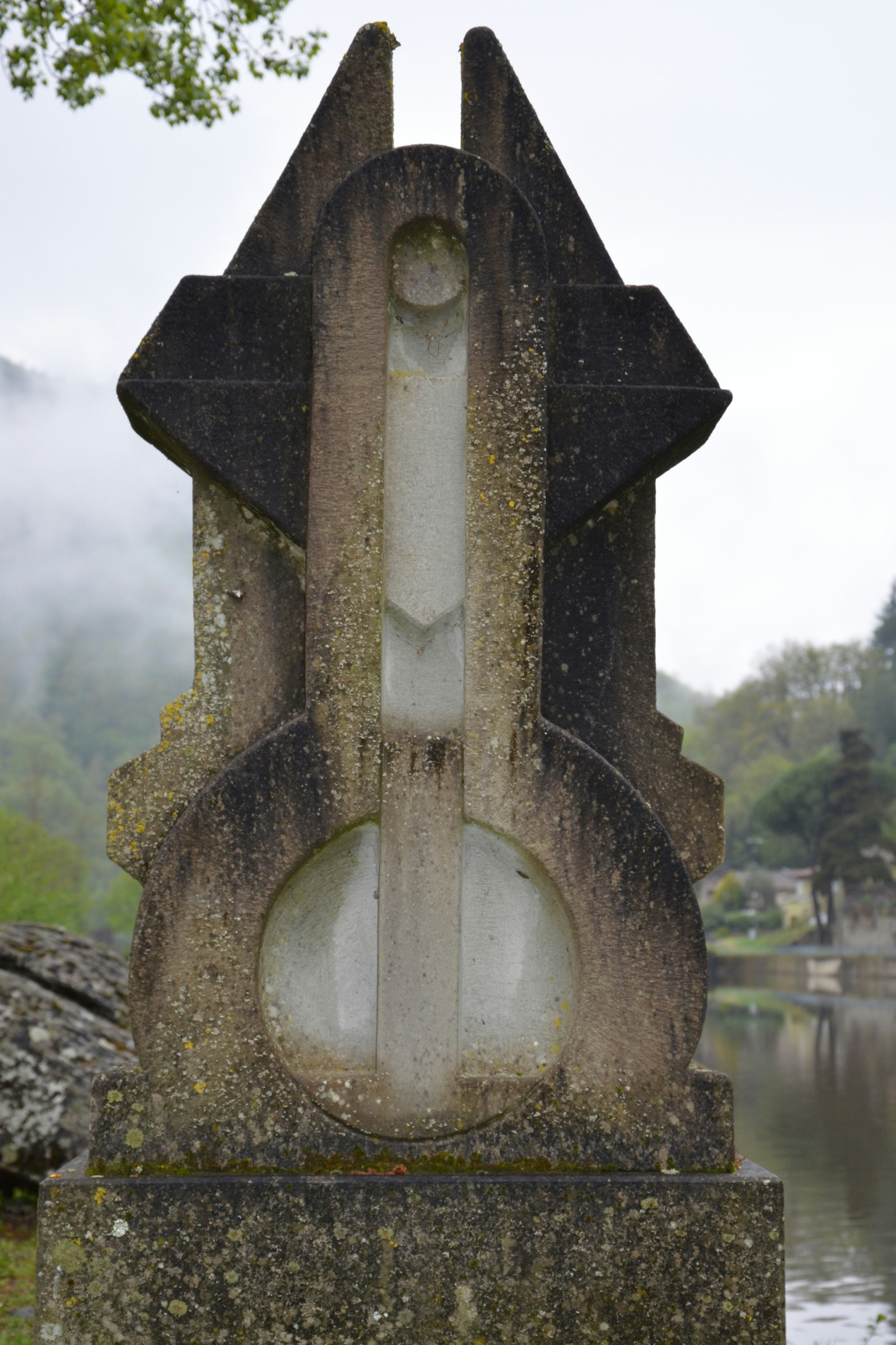a stone cross on a stone wall