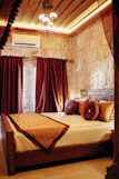 a bed with red curtains