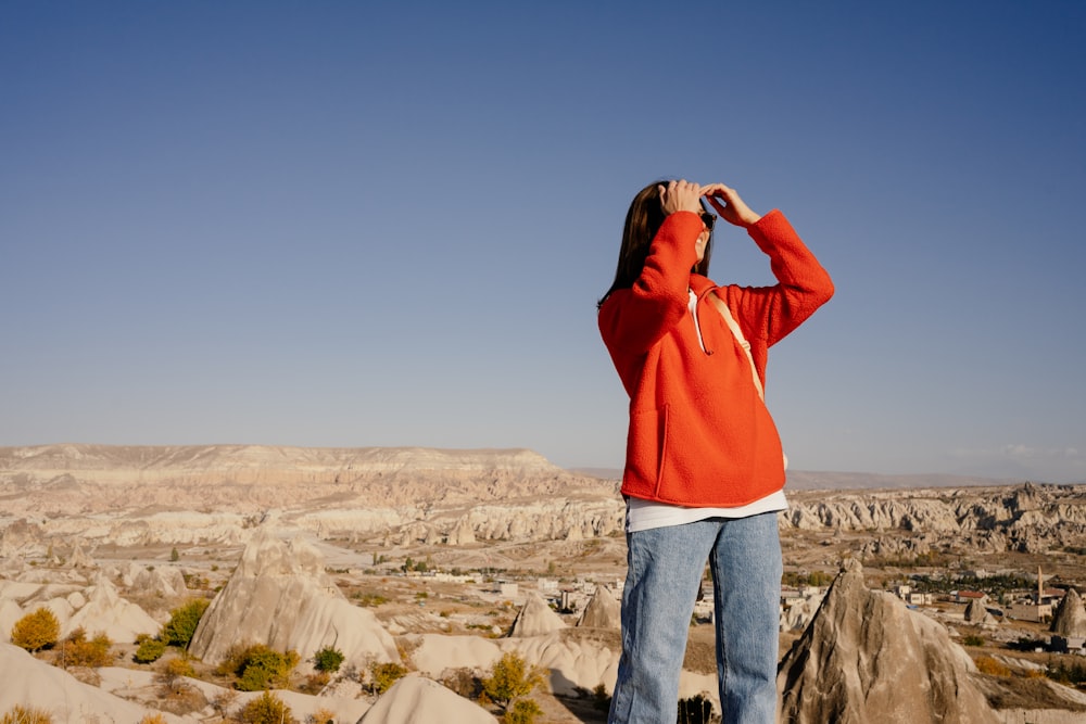 a man taking a picture of a canyon