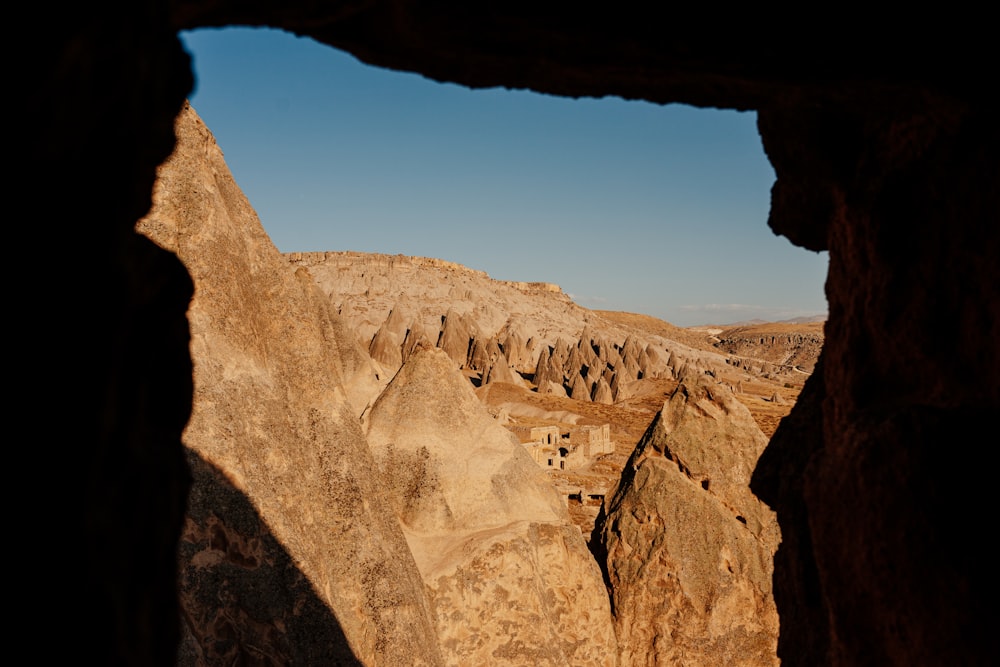 a view of a canyon from inside a cave