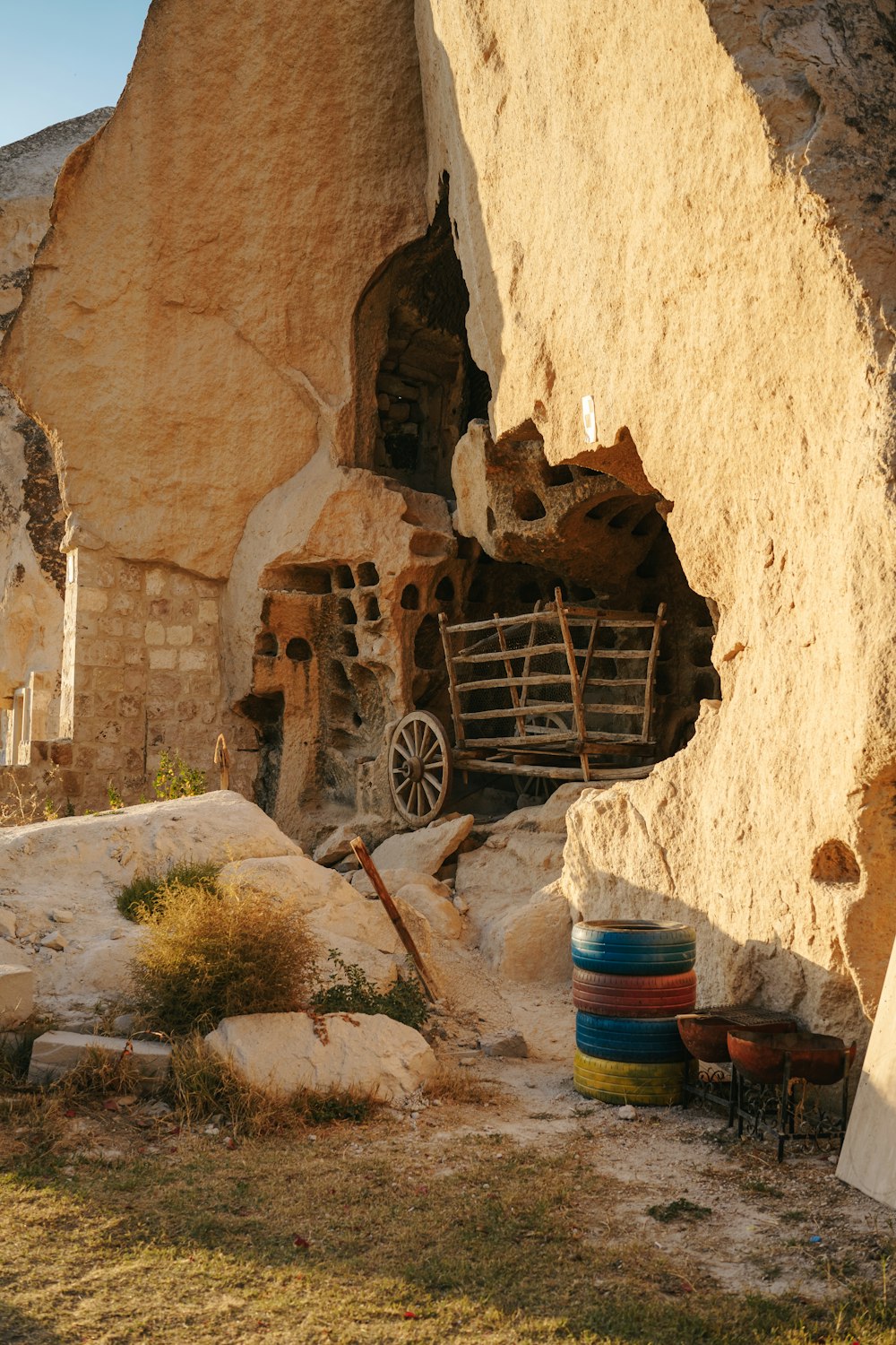 a stone building with a wheelbarrow and a wheelbarrow