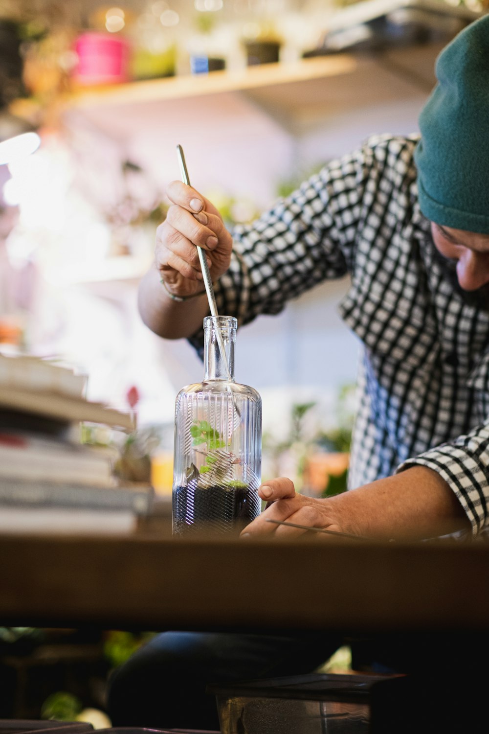 a person pouring a drink into a glass