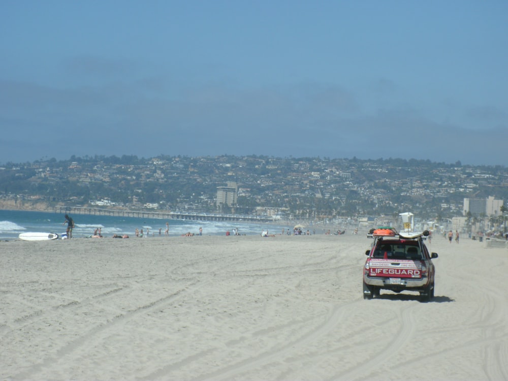 a red truck on a beach