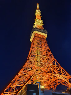 Evening view of Tower 3 with warm interior lights glowing.