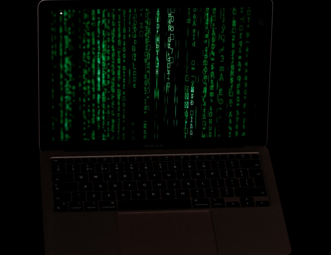 a laptop with a green screen, Low key photo of a Mac book
