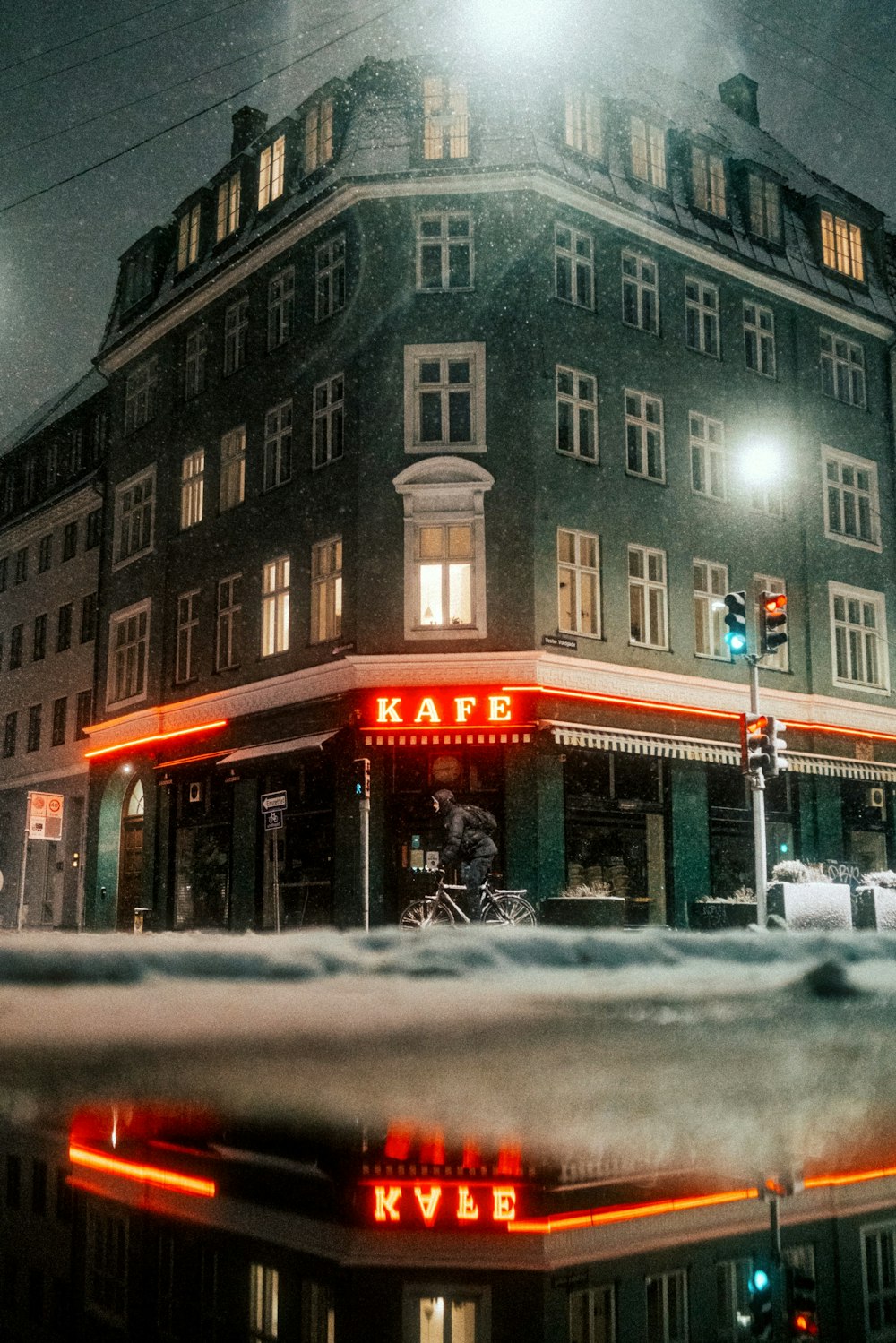 a building with a person riding a bicycle in front of it