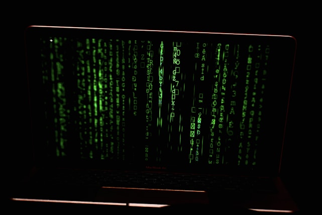 A dark terminal interface with glowing green code streams and data grids.