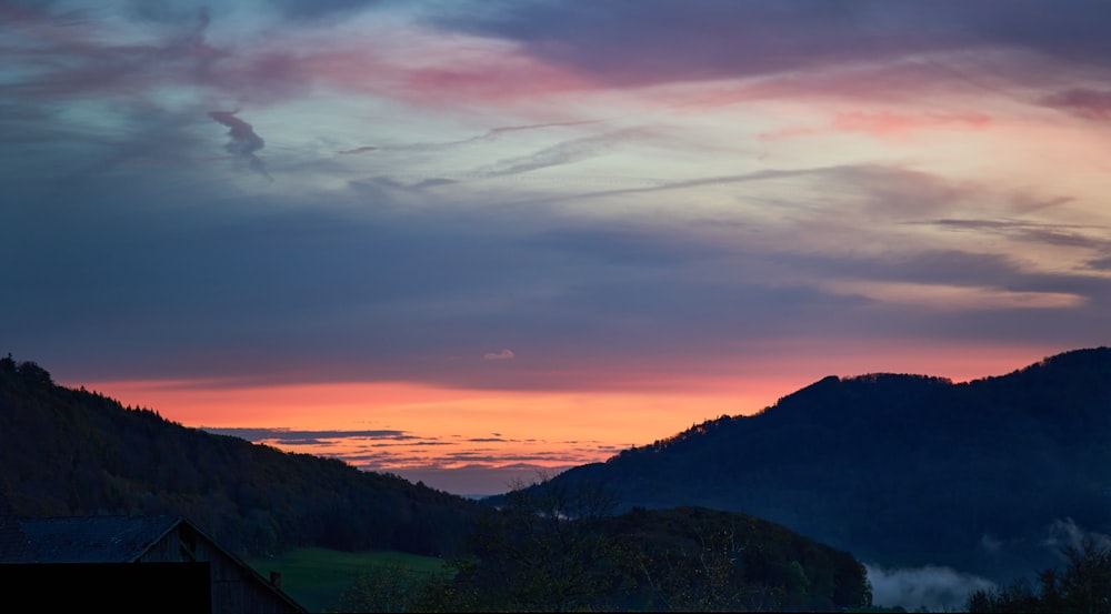 a sunset over a mountain range