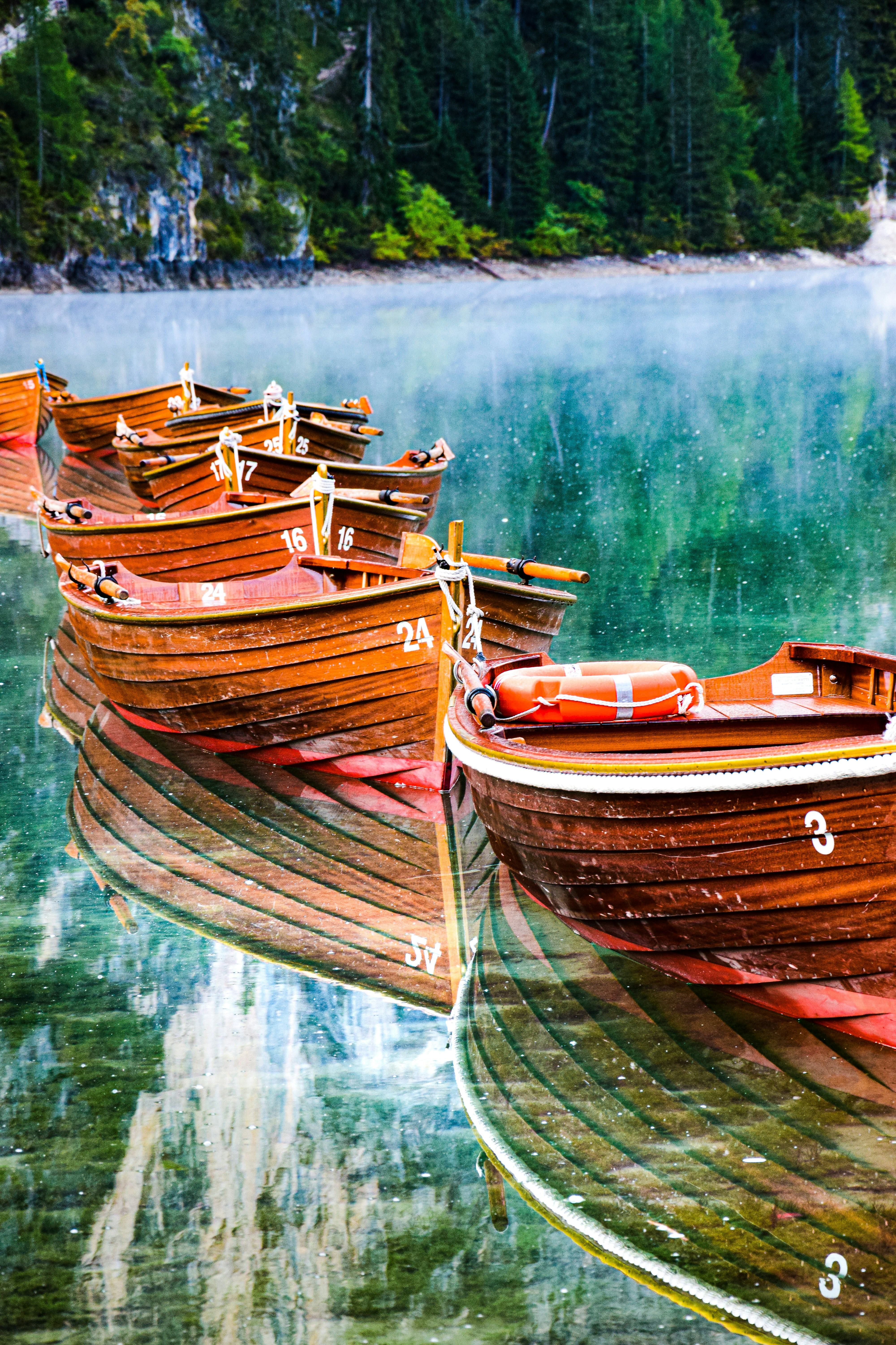 A group of boats sit on the water photo – Free Lago di braies Image on ...