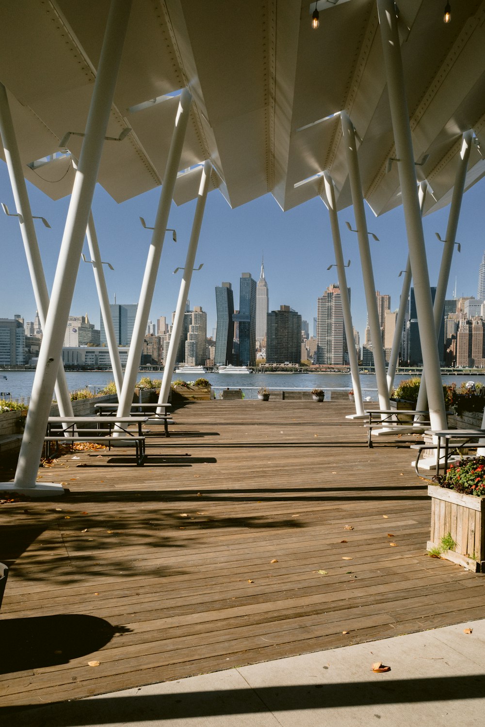 a wooden deck with a view of a city and water