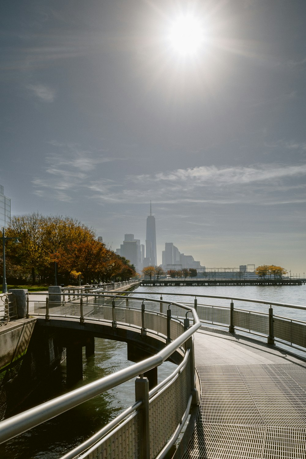 a bridge over a body of water with a city in the background