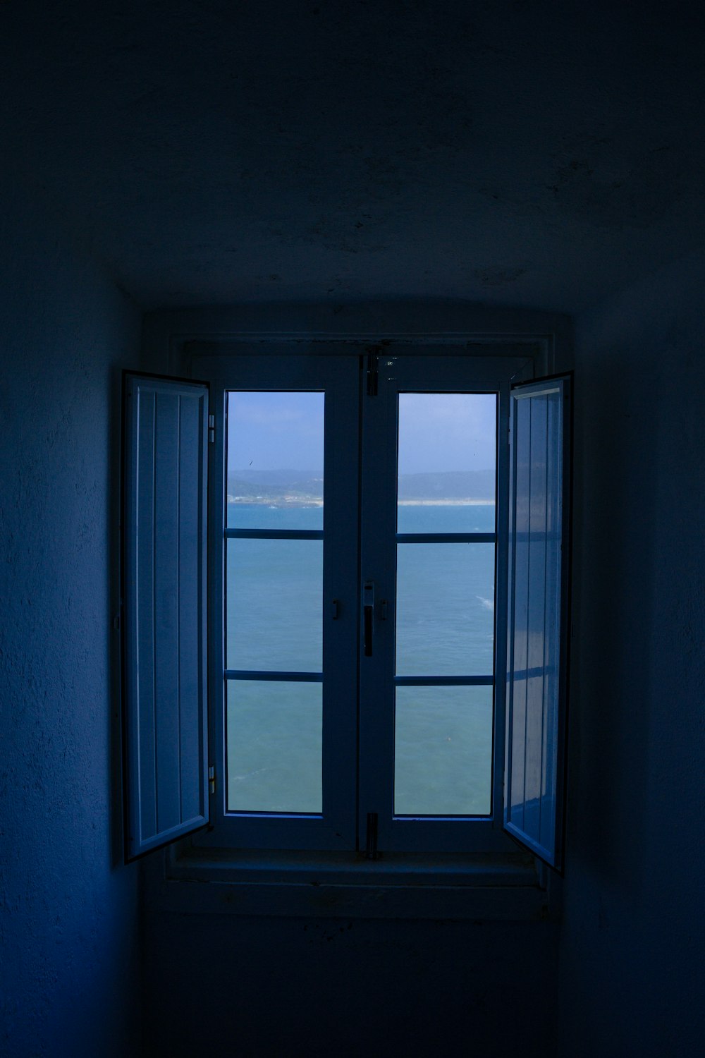 a window with a view of the ocean