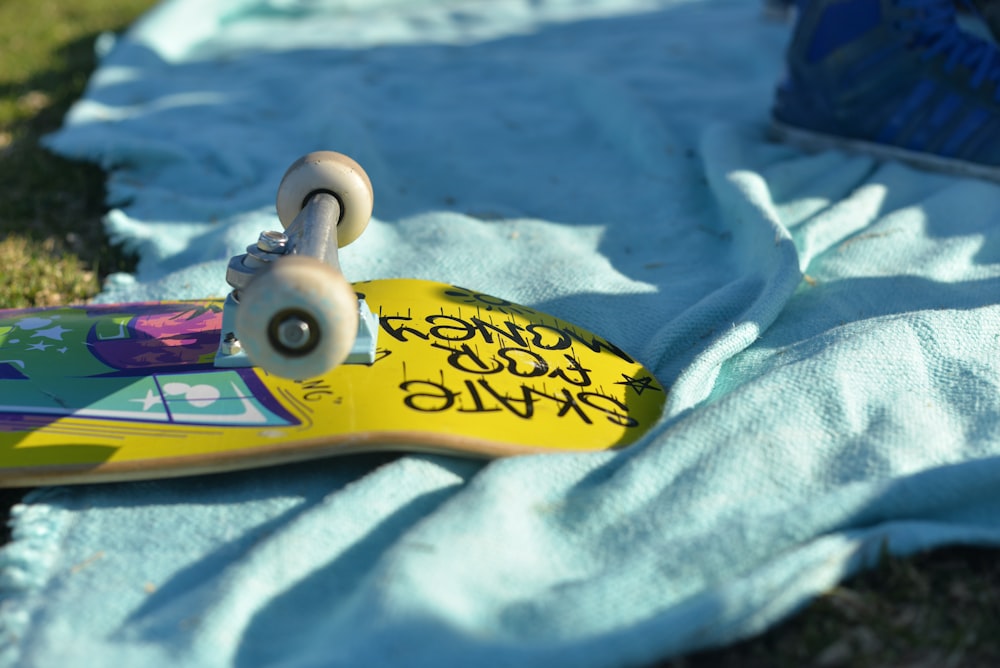 a yellow and blue surfboard on a blanket