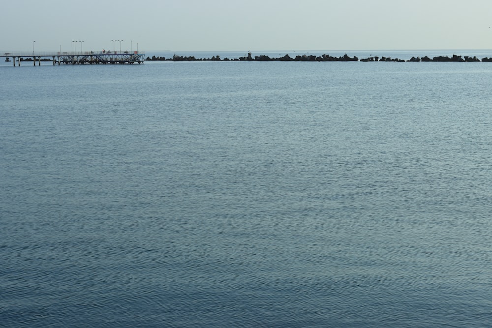 a body of water with a dock and a pier in the distance