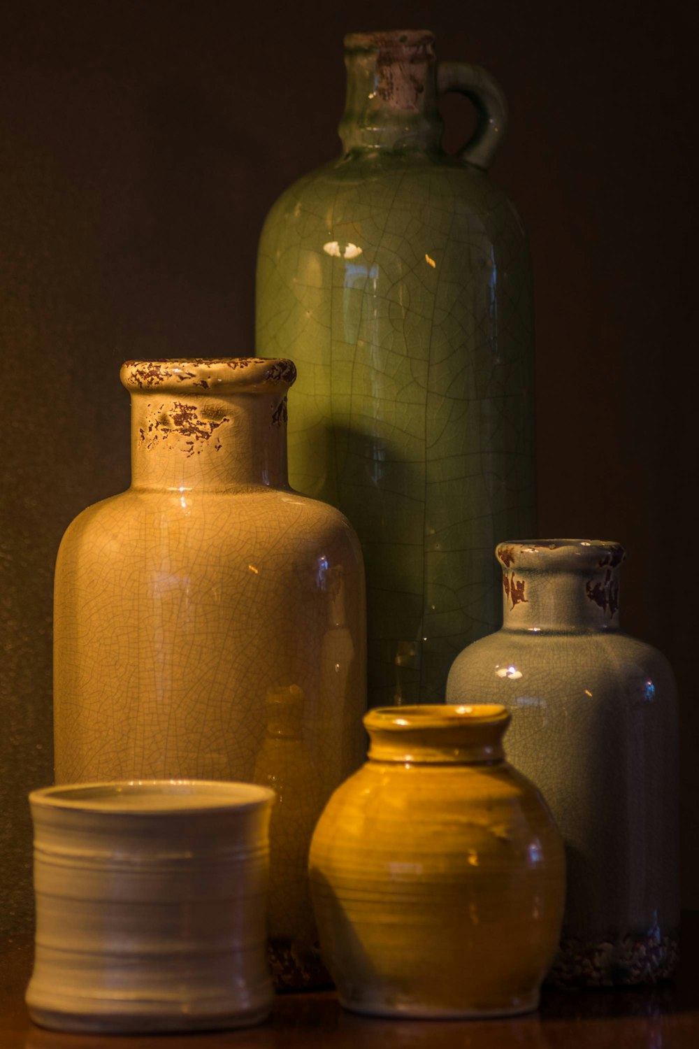 a group of vases sit on a shelf