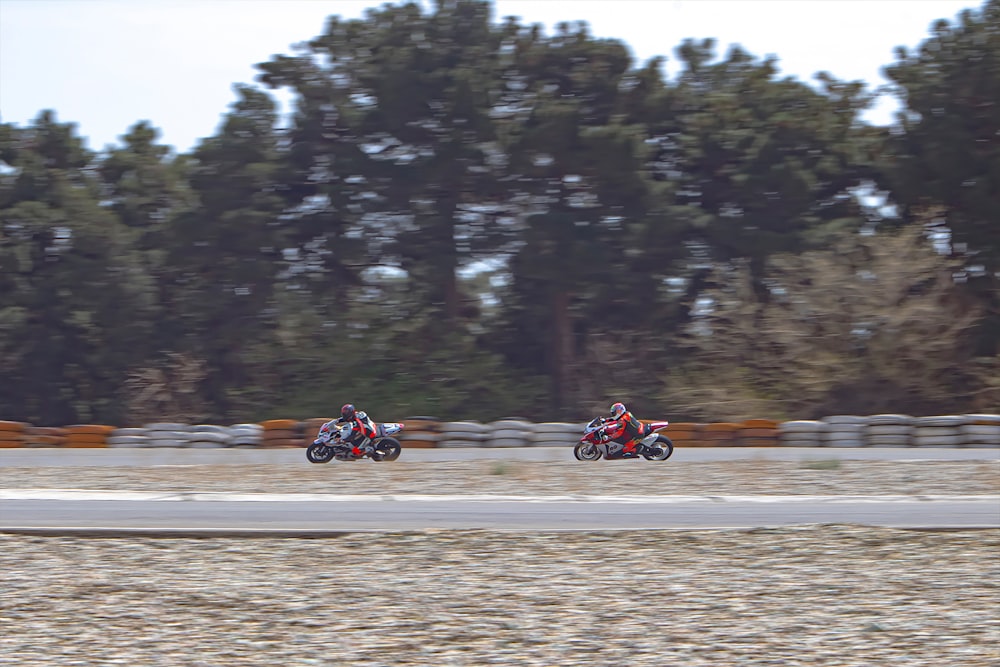 two people riding motorcycles