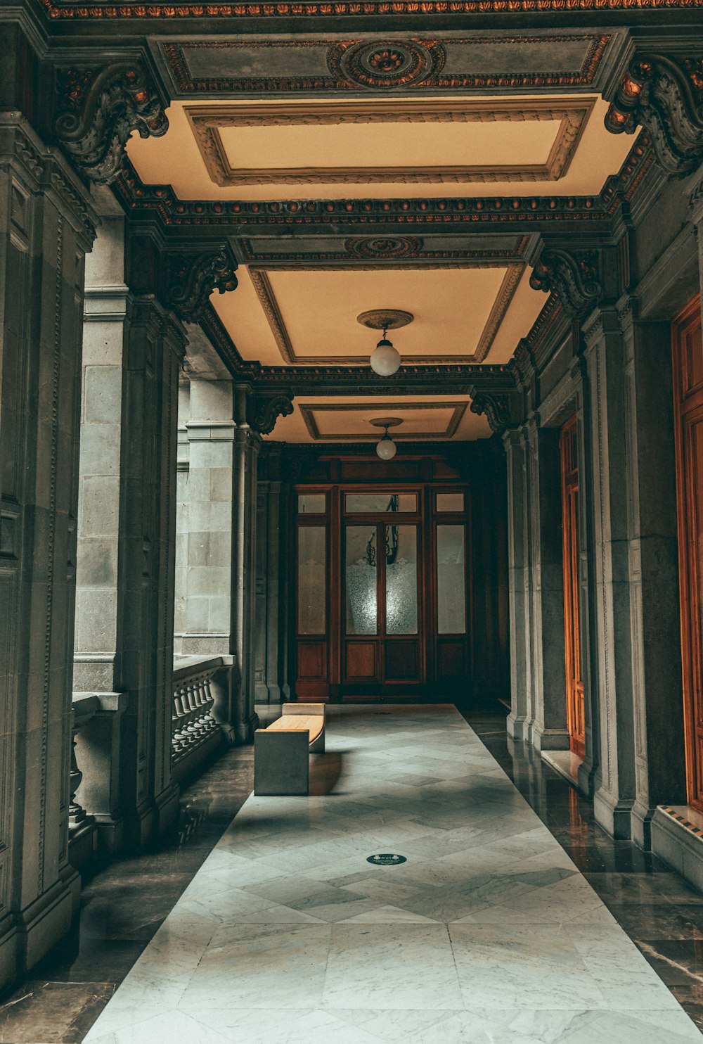 a large ornate hallway with a bench