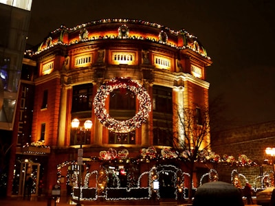 The historic Kress building beautifully lit up with twinkling lights and holiday decorations at dusk.