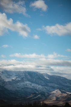 Snow-capped mountains under a clear blue sky, inviting adventure seekers.