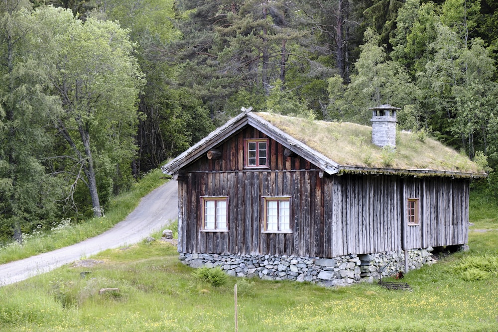 a wooden house with a stone wall